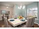 Bright dining room featuring a marble-topped table, modern lighting, and an elegant mirror and console table at 2101 Slick Stone Dr, Snellville, GA 30078