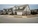Street view of attractive townhomes featuring brick accents, two-car garages, and manicured lawns at 2101 Slick Stone Dr, Snellville, GA 30078