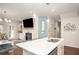 Modern kitchen island with bar seating and an open view of the adjoining living space at 2101 Slick Stone Dr, Snellville, GA 30078