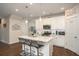 Modern kitchen island with bar seating, pendant lighting, and stainless steel appliances at 2101 Slick Stone Dr, Snellville, GA 30078