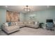Comfortable living room with a large sectional sofa, accent pillows, and stylish artwork at 2101 Slick Stone Dr, Snellville, GA 30078
