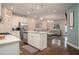 Open-concept living space with a kitchen island, modern furnishings, and hardwood floors at 2101 Slick Stone Dr, Snellville, GA 30078