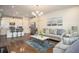 Inviting open-concept living space with a kitchen island, comfortable seating, and modern decor at 2101 Slick Stone Dr, Snellville, GA 30078