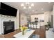 Open living area showcasing a fireplace, kitchen island with bar stools, and modern design at 2101 Slick Stone Dr, Snellville, GA 30078