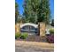 Stone sign for Woodlake Landing community surrounded by greenery at 8056 S Bay Ct, Riverdale, GA 30274