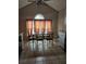 Dining room with large window, tiled floor, and vaulted ceilings at 8056 S Bay Ct, Riverdale, GA 30274