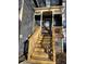 View of front porch with wooden stairs and decorative lattice at 8056 S Bay Ct, Riverdale, GA 30274