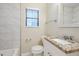 Bathroom with white vanity, granite countertop, and tiled tub surround at 3511 Misty Valley Rd, Decatur, GA 30032