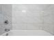 Close-up of updated white tile tub surround with chrome hardware at 3511 Misty Valley Rd, Decatur, GA 30032
