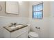 Bathroom featuring a granite vanity, toilet, towel rack and window with blinds at 3511 Misty Valley Rd, Decatur, GA 30032