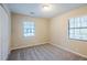 Bedroom featuring two windows with blinds, plush carpet, and a closet at 3511 Misty Valley Rd, Decatur, GA 30032