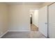 Bedroom featuring neutral walls, plush carpeting, and a hallway view with wood-style flooring at 3511 Misty Valley Rd, Decatur, GA 30032