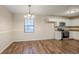 Open dining area with wood floors next to the renovated kitchen at 3511 Misty Valley Rd, Decatur, GA 30032