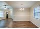 Bright dining room with wood floors, a modern light fixture, and a large window at 3511 Misty Valley Rd, Decatur, GA 30032