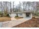 View of the home with a walkway leading to the front door and covered parking at 3511 Misty Valley Rd, Decatur, GA 30032