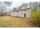 Backyard and exterior of home with light brick and door to basement at 3527 Glenview Sw Cir, Atlanta, GA 30331