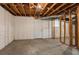 Unfinished basement with concrete floors, and door to backyard at 3527 Glenview Sw Cir, Atlanta, GA 30331