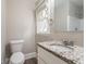 Bathroom featuring granite vanity, ceramic tile shower and patterned window at 3527 Glenview Sw Cir, Atlanta, GA 30331
