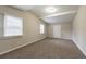 Bright room featuring neutral paint, gray carpet, and a vaulted ceiling with beam at 3527 Glenview Sw Cir, Atlanta, GA 30331