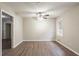 Bedroom featuring neutral paint, wood-look floors, a ceiling fan and a large window that provides ample natural light at 3527 Glenview Sw Cir, Atlanta, GA 30331