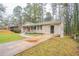 Side view showcasing the home's brick exterior, a driveway leading to the side door, and a well-kept front yard at 3527 Glenview Sw Cir, Atlanta, GA 30331