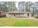 Charming single-story home with a well-manicured front yard, inviting walkway, and a pop of color with a red front door at 3527 Glenview Sw Cir, Atlanta, GA 30331