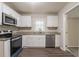 Updated kitchen with white cabinets, granite countertops, and stainless steel appliances, all complemented by modern wood-look flooring at 3527 Glenview Sw Cir, Atlanta, GA 30331