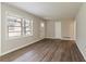 Bright living room featuring neutral paint, wood-look floors, and a white front door and trim at 3527 Glenview Sw Cir, Atlanta, GA 30331