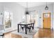 Bright dining area with a modern chandelier, large windows, and wood flooring at 569 Hope Sw St, Atlanta, GA 30310