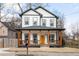 Charming two-story home with a welcoming front porch and a vibrant yellow door at 569 Hope Sw St, Atlanta, GA 30310
