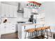 Stylish kitchen with white cabinets, stainless steel appliances, and a breakfast bar at 569 Hope Sw St, Atlanta, GA 30310