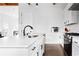 Modern kitchen features white cabinets, a stainless steel sink, and sleek black fixtures at 569 Hope Sw St, Atlanta, GA 30310