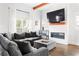 Comfortable living area with a gray sofa, modern fireplace, and plenty of natural light at 569 Hope Sw St, Atlanta, GA 30310