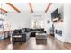 Cozy living area featuring a comfortable sectional sofa, fireplace, and wood beam accents at 569 Hope Sw St, Atlanta, GA 30310