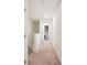 Upstairs hallway with neutral carpet leading to an open closet and offering ample lighting at 815 Taurus Dr, Stockbridge, GA 30281
