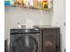 Convenient laundry room featuring modern Samsung washer and dryer and practical shelving at 815 Taurus Dr, Stockbridge, GA 30281