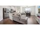 Inviting open-concept living space with stainless steel appliances, granite countertops, and a comfortable couch at 815 Taurus Dr, Stockbridge, GA 30281