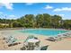 Resort-style pool surrounded by lounge chairs and lush greenery, perfect for relaxation and recreation at 815 Taurus Dr, Stockbridge, GA 30281