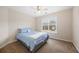 Bright bedroom with a large window, carpet flooring, and neutral walls at 130 Brookridge Ct, Fayetteville, GA 30215