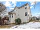 Two-story home with large windows, a deck, and partially snow covered landscaping at 130 Brookridge Ct, Fayetteville, GA 30215