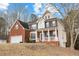 A charming two-story brick home with a two-car garage and a lovely front porch at 130 Brookridge Ct, Fayetteville, GA 30215