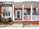 Inviting front porch with white columns and railing, leading to the front door at 130 Brookridge Ct, Fayetteville, GA 30215