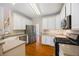 Traditional kitchen featuring white cabinets, stainless steel appliances, and hardwood floors at 130 Brookridge Ct, Fayetteville, GA 30215