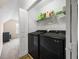 Functional laundry room with modern washer and dryer units, shelving and extra storage at 130 Brookridge Ct, Fayetteville, GA 30215