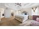 Spacious primary bedroom with a tray ceiling, and a sitting area at 130 Brookridge Ct, Fayetteville, GA 30215