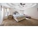 Spacious primary bedroom with a tray ceiling, and a sitting area at 130 Brookridge Ct, Fayetteville, GA 30215