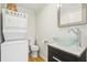 Modern bathroom with a vessel sink, stainless steel faucet, and stacked washer-dryer at 2184 Clairmont Ne Ter, Atlanta, GA 30345