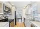 Modern kitchen with stainless steel appliances, white cabinets, and tile backsplash at 2184 Clairmont Ne Ter, Atlanta, GA 30345