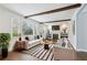 Bright living room with hardwood floors, white walls, a fireplace, and exposed beam ceilings at 2184 Clairmont Ne Ter, Atlanta, GA 30345