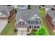 Aerial view of a two-story brick home with manicured lawn and two-car garage at 4340 Bluejay Pl, Cumming, GA 30041